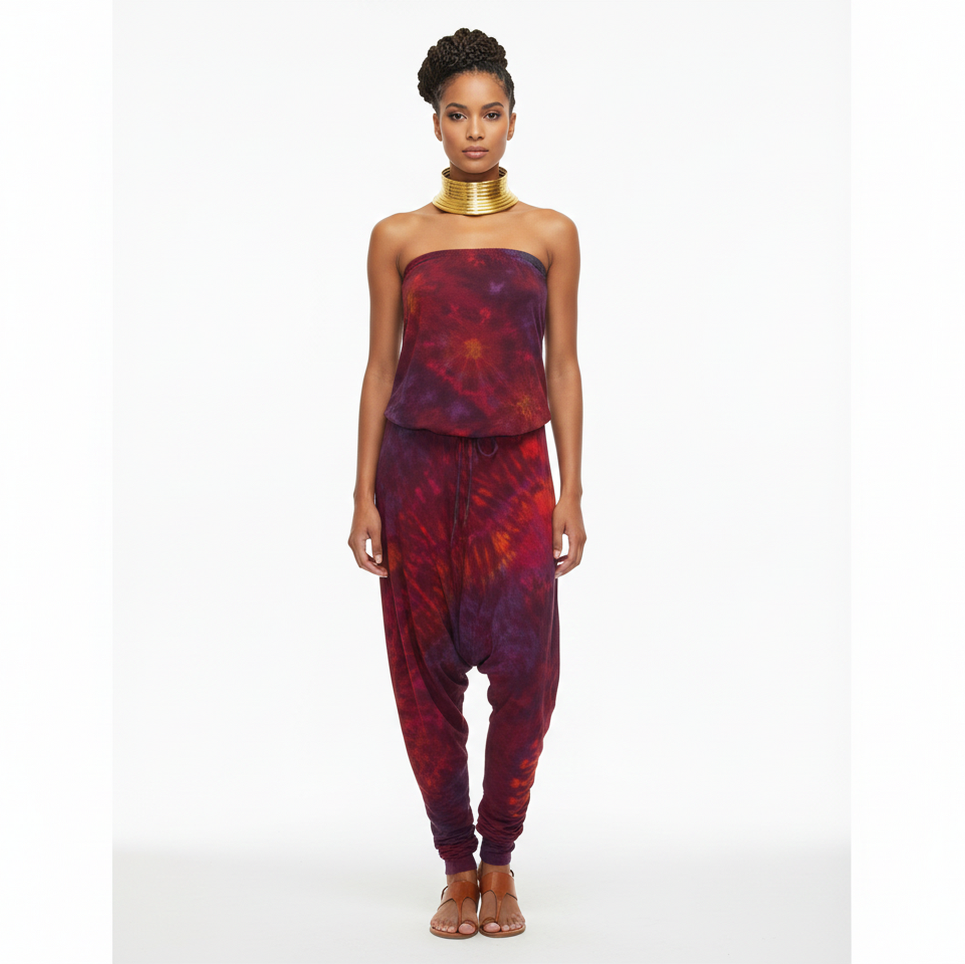Woman wearing a red and purple tie-dye jumpsuit on a white background
