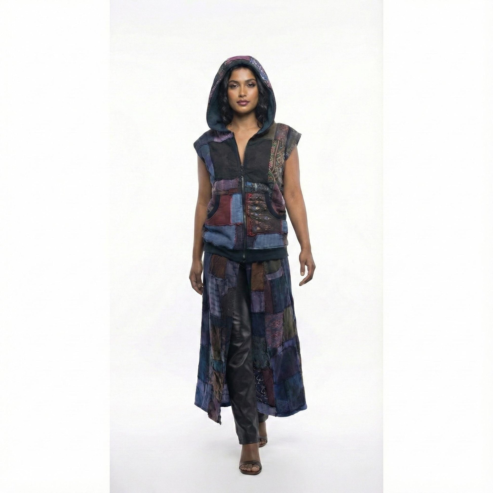 Person wearing a patchwork vest with a hood on a white background