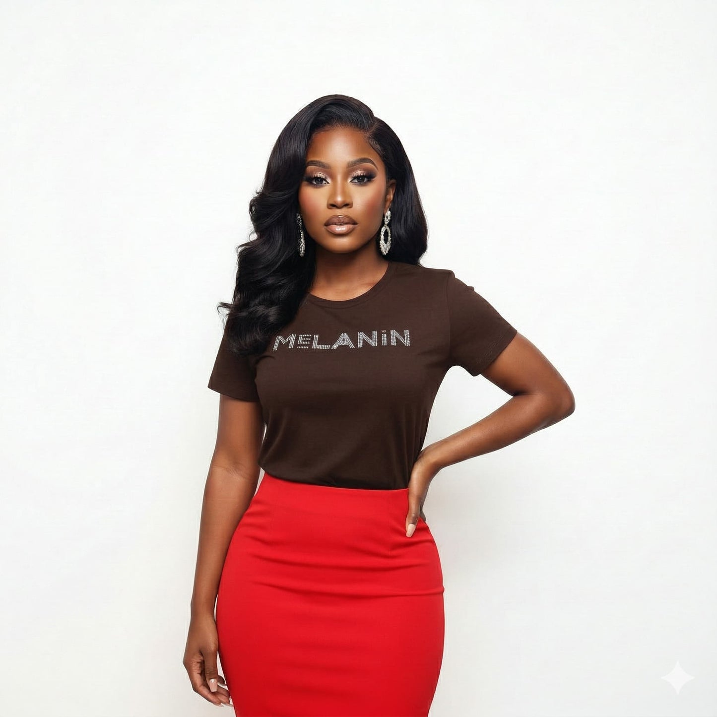 Woman in a brown "MELANIN" bling tee, red skirt, and statement earrings.