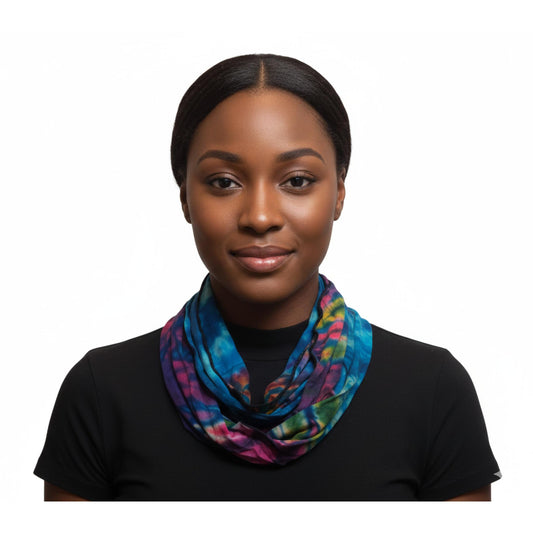 Woman wearing a colorful tie dye scarf on a white background