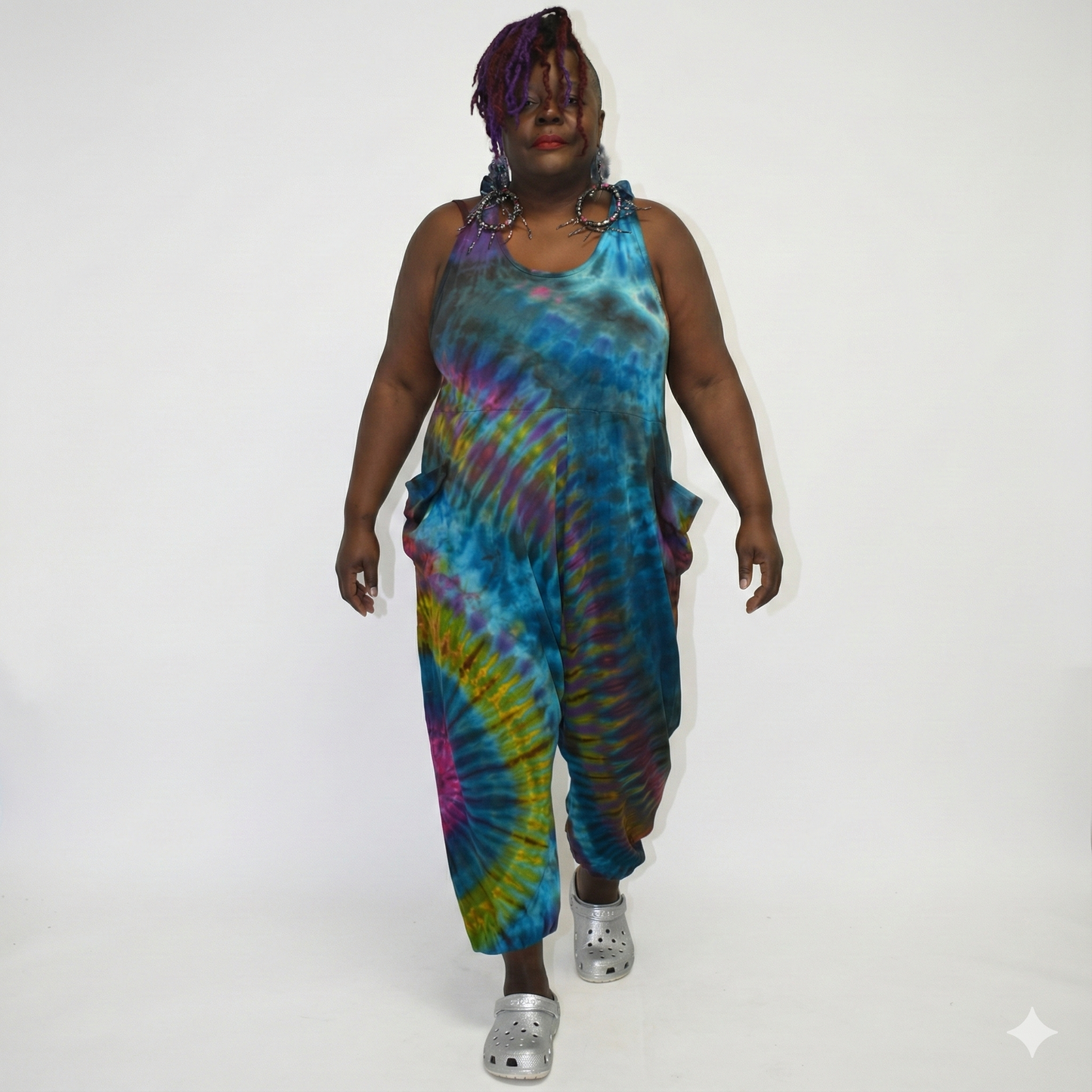 Person wearing a tie-dye jumpsuit on a white background