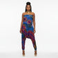 Woman wearing a colorful tie-dye strapless harem jumpsuit  on a white background