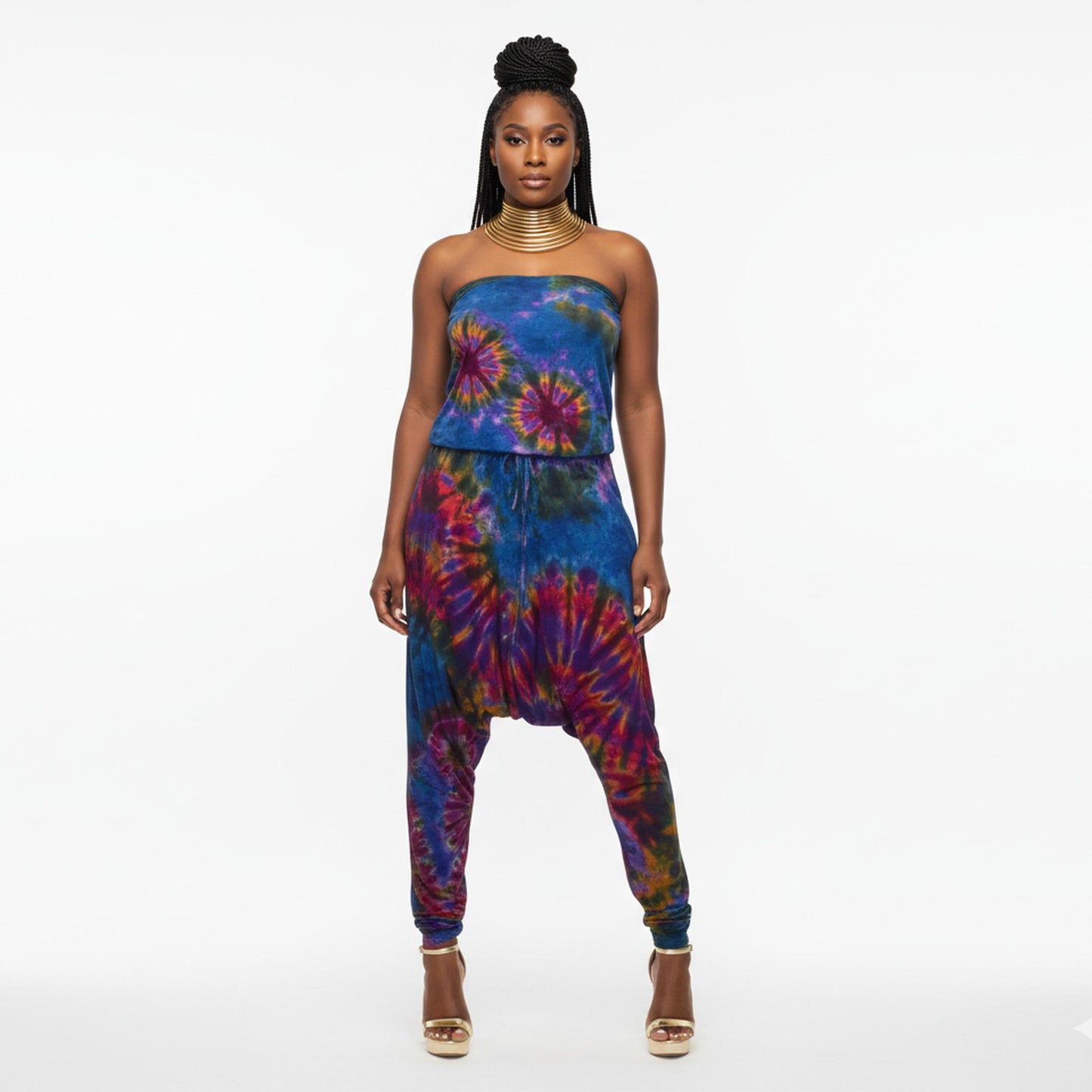 Woman wearing a colorful tie-dye strapless harem jumpsuit  on a white background