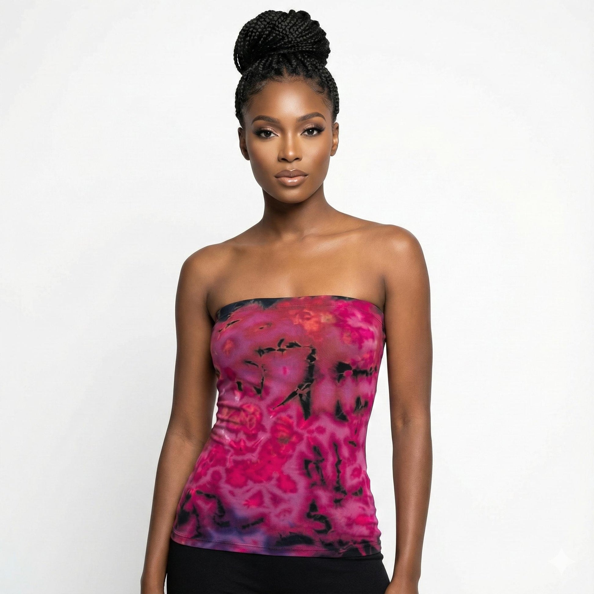 Woman wearing a strapless pink and black patterned top on a white background