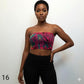 Woman wearing a colorful tube top against a plain background