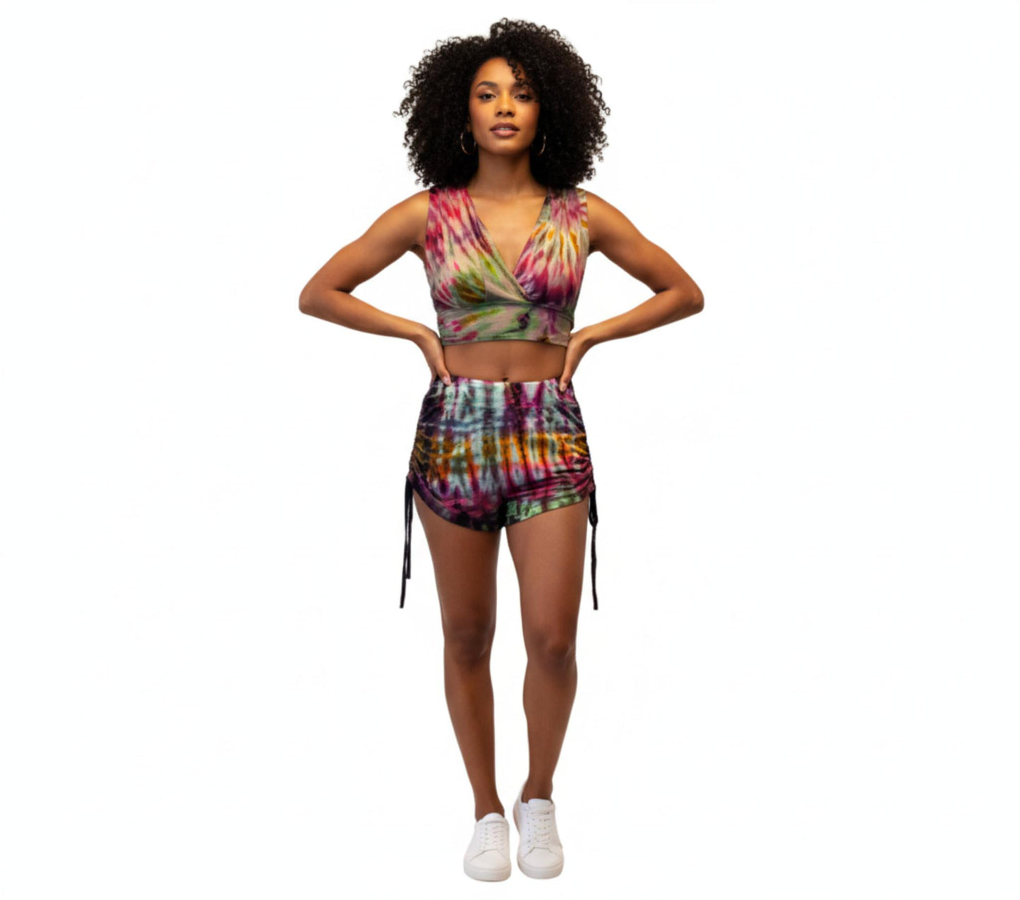 Woman wearing a colorful tie-dye 2 pc outfit on a white background