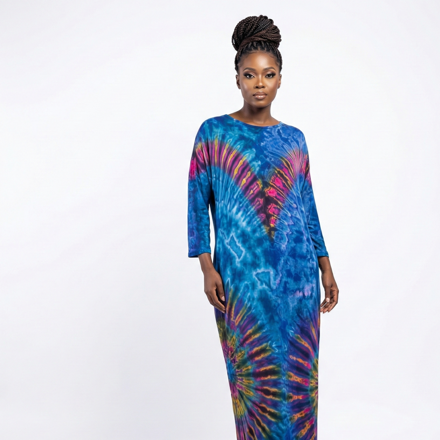 Woman wearing a colorful tie-dye dress on a white background