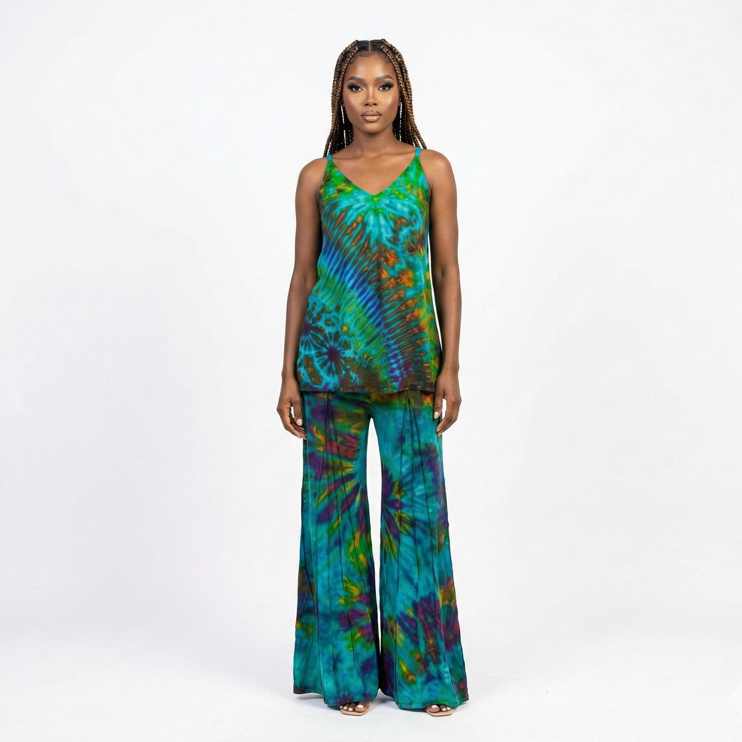 Woman wearing a pants and top tie-dye outfit on a white background