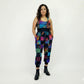 Woman wearing a colorful patchwork joggers jumpsuit on a white background