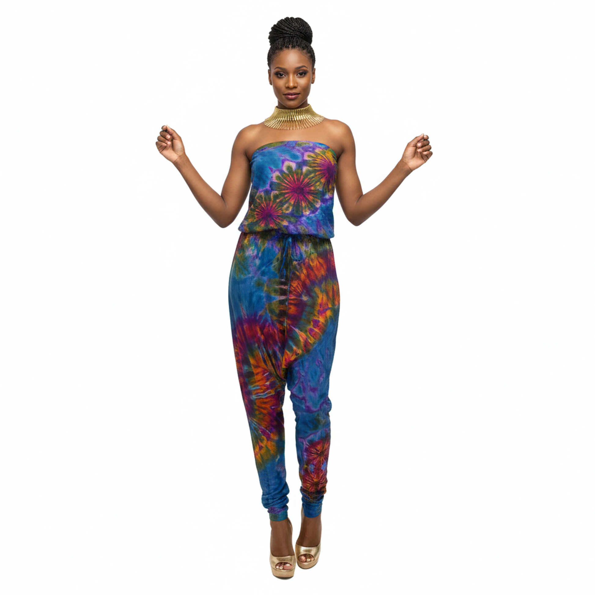 Woman wearing a colorful tie-dye strapless jumpsuit on a white background