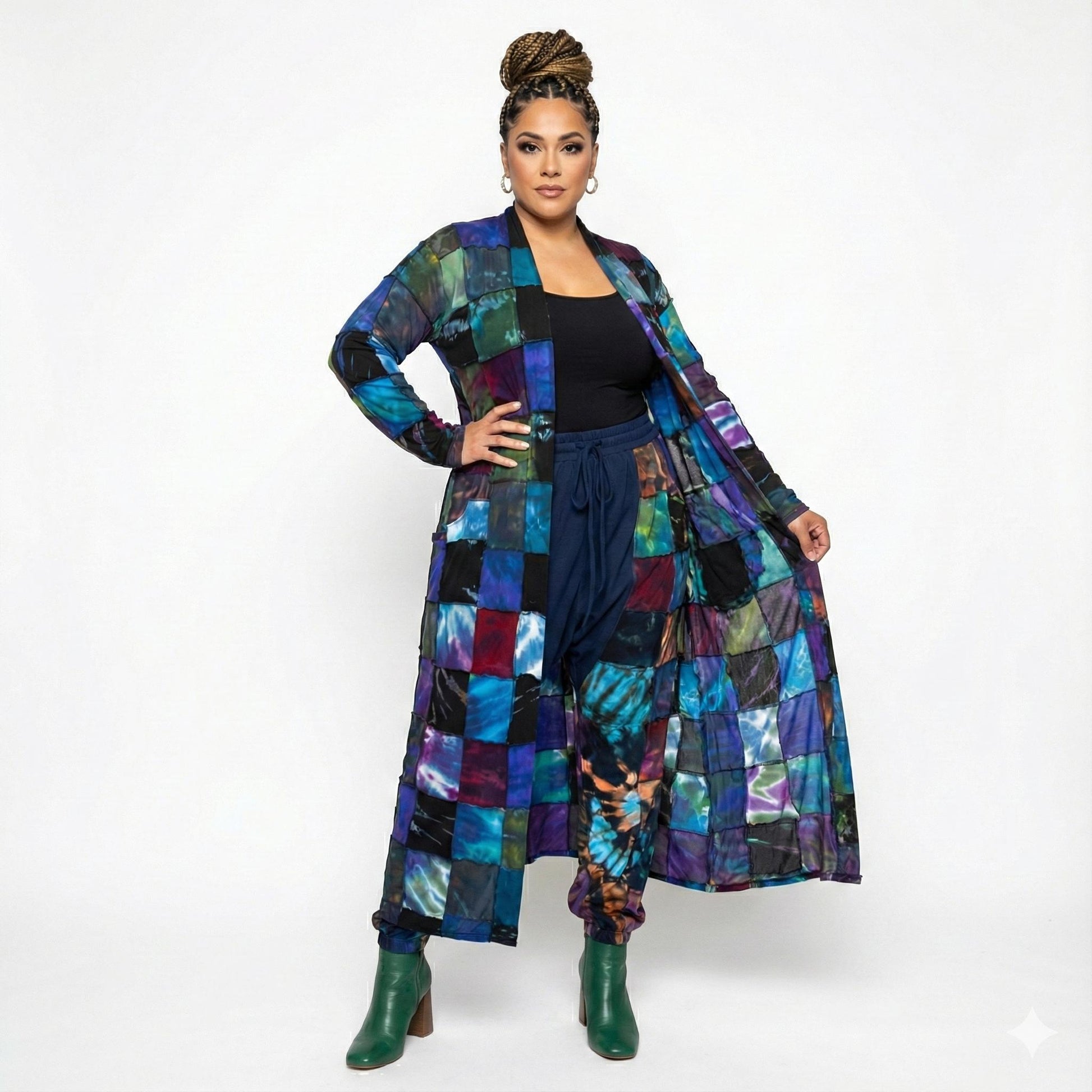 Woman wearing a colorful patchwork duster and pants on a white background