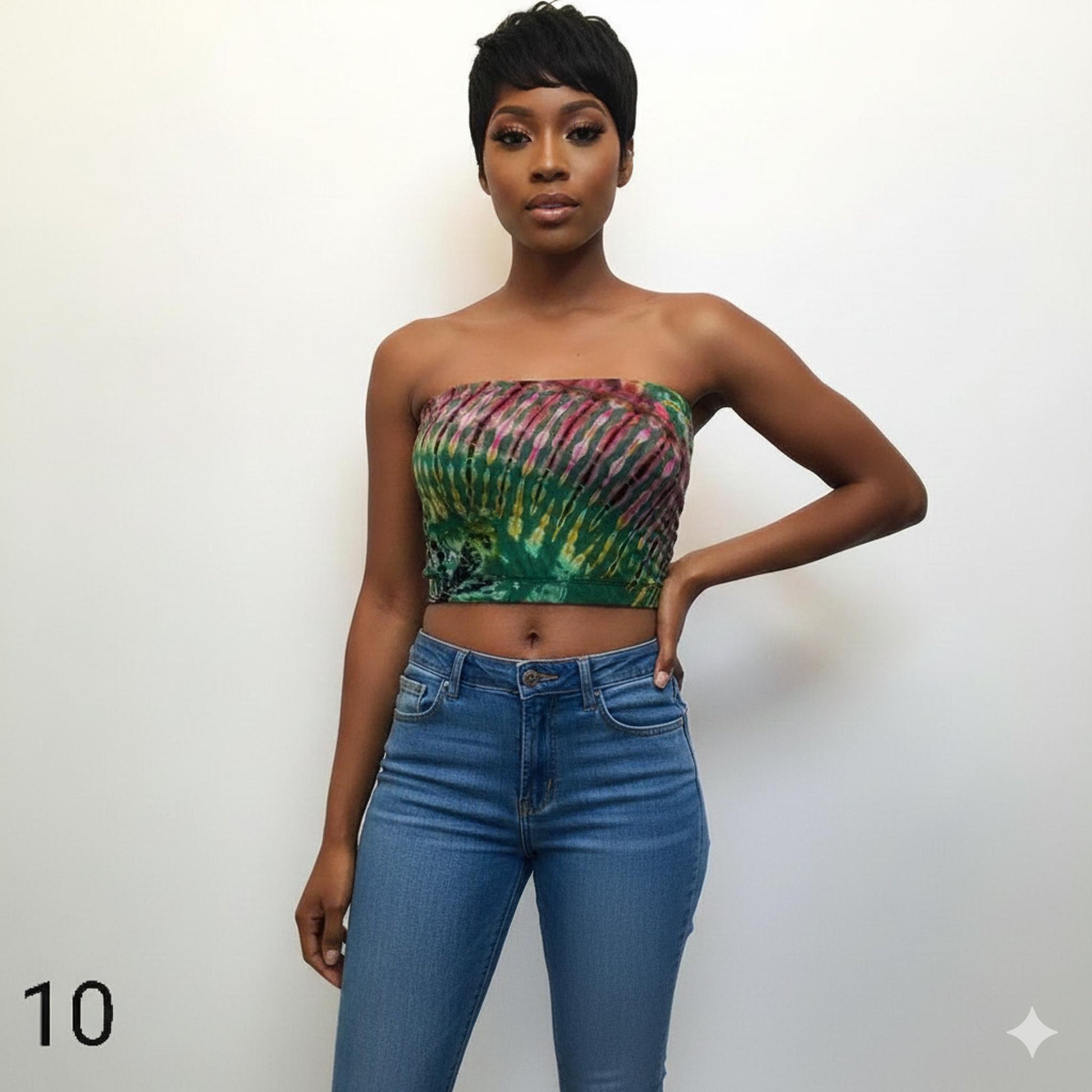 Woman wearing a tie-dye tube top and blue jeans against a white background