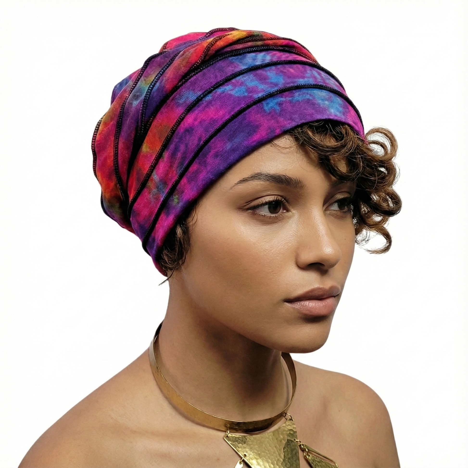 Woman wearing a colorful tie dye hat on a white background