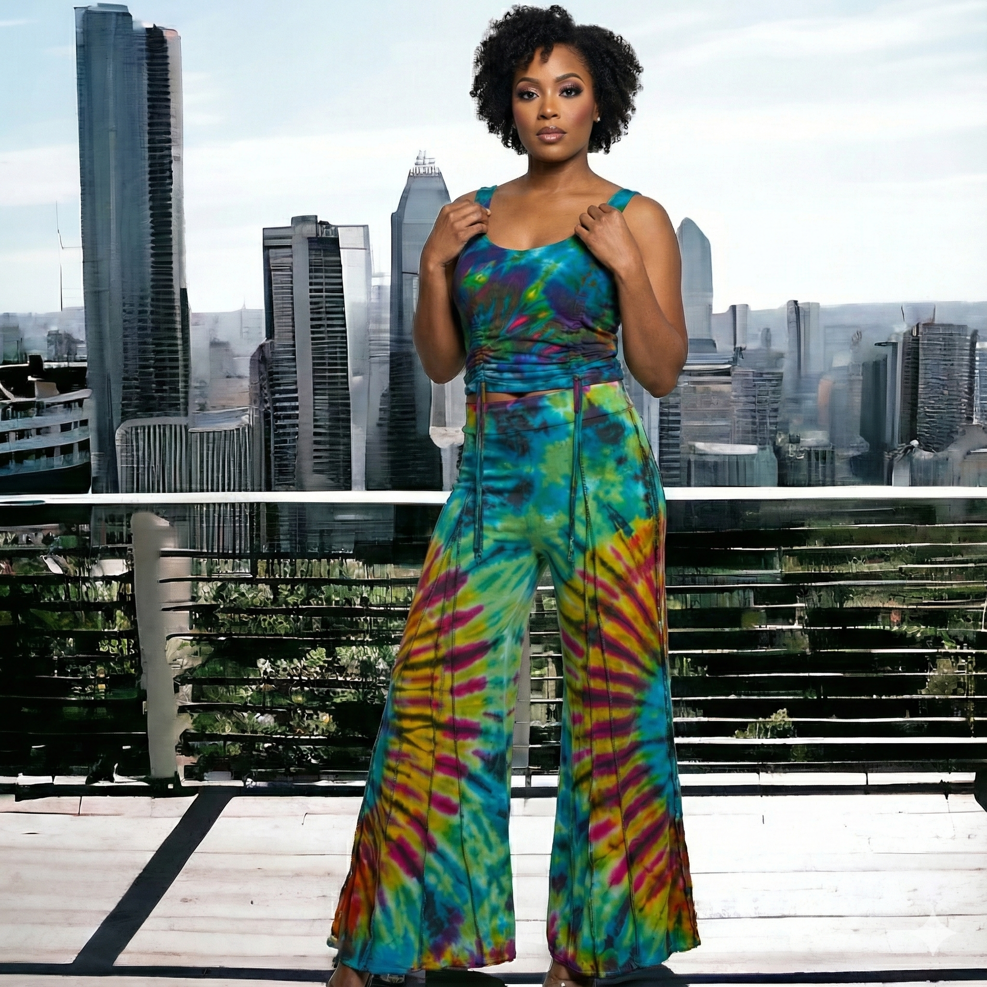 Woman wearing a colorful tie-dye jumpsuit with a cityscape background