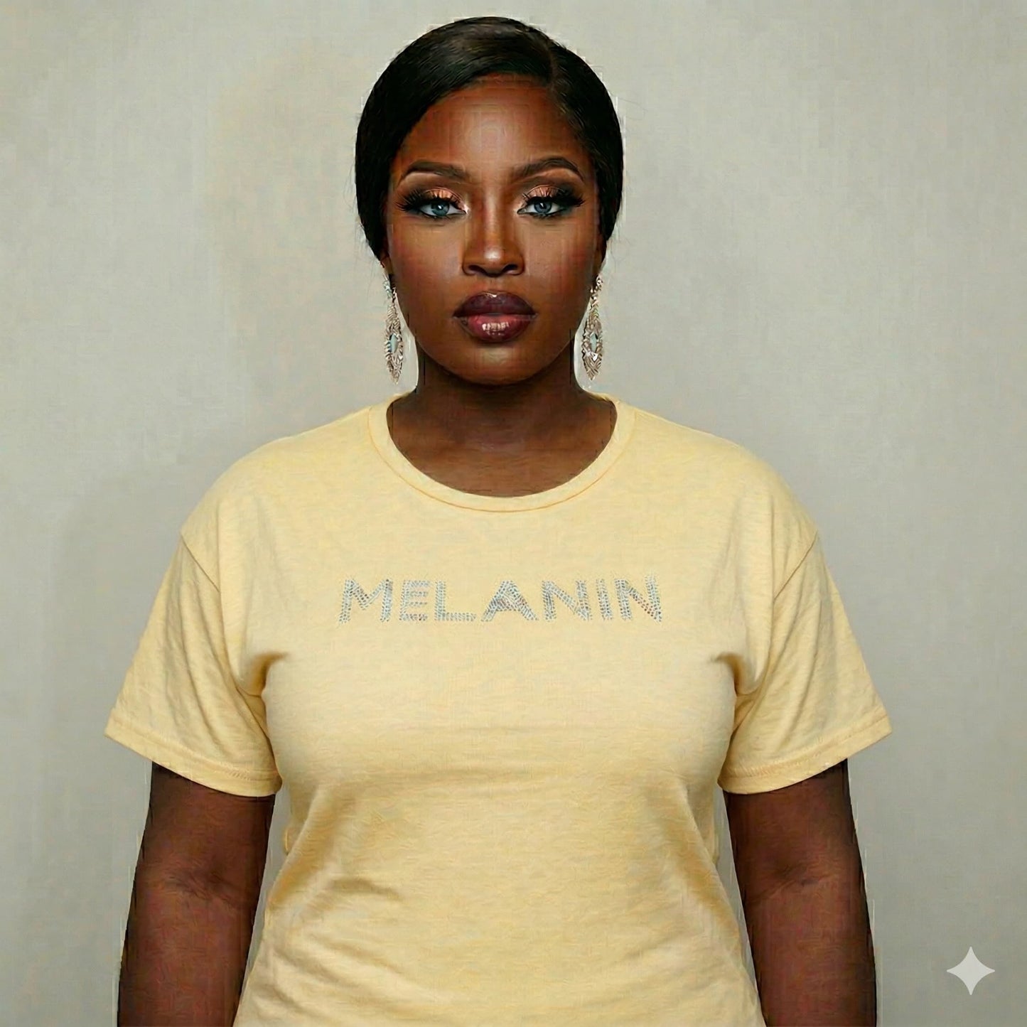 Woman in a yellow "MELANIN" bling tee, showcasing Black pride and beauty.