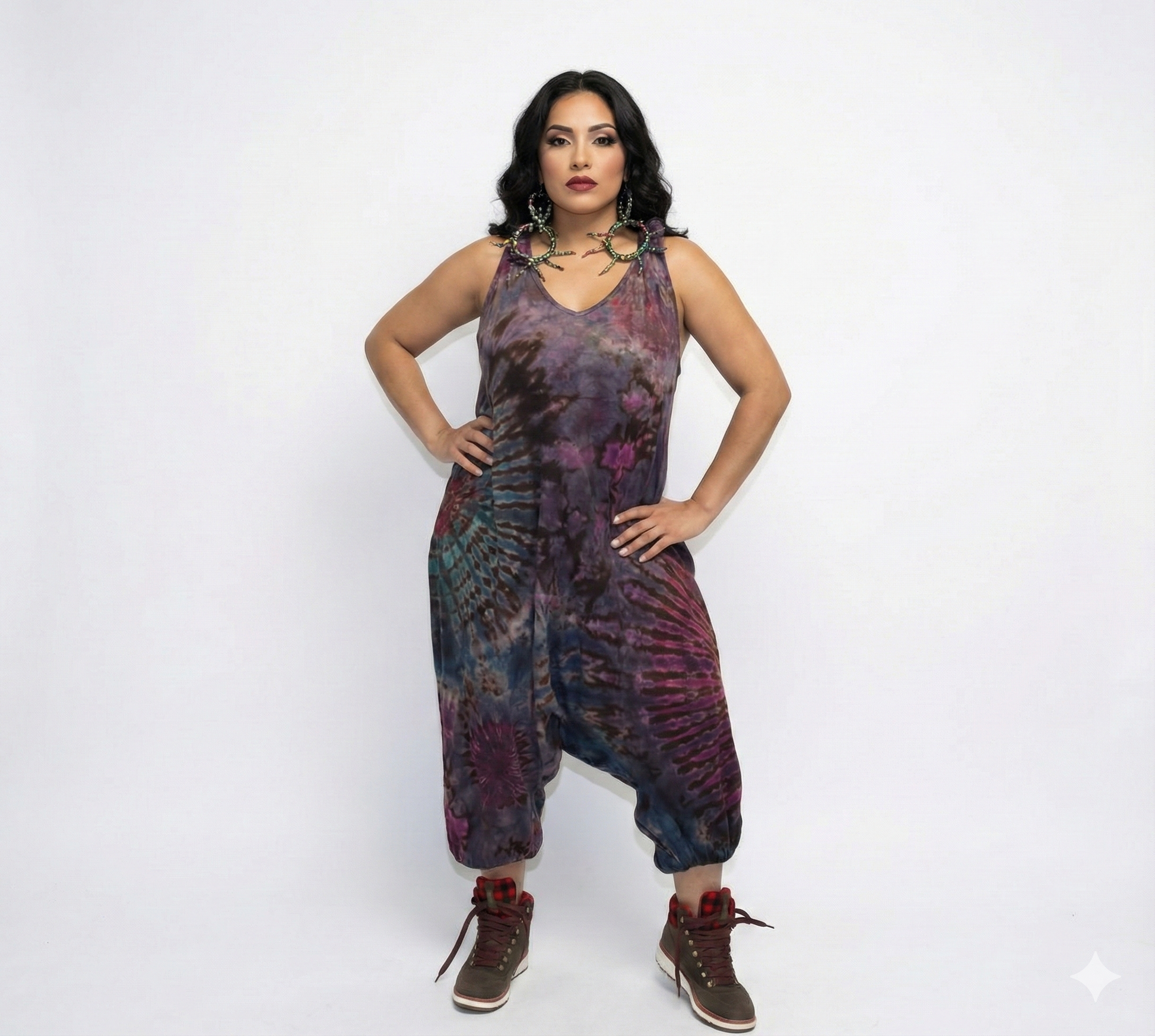 Woman wearing a tie-dye jumpsuit on a white background