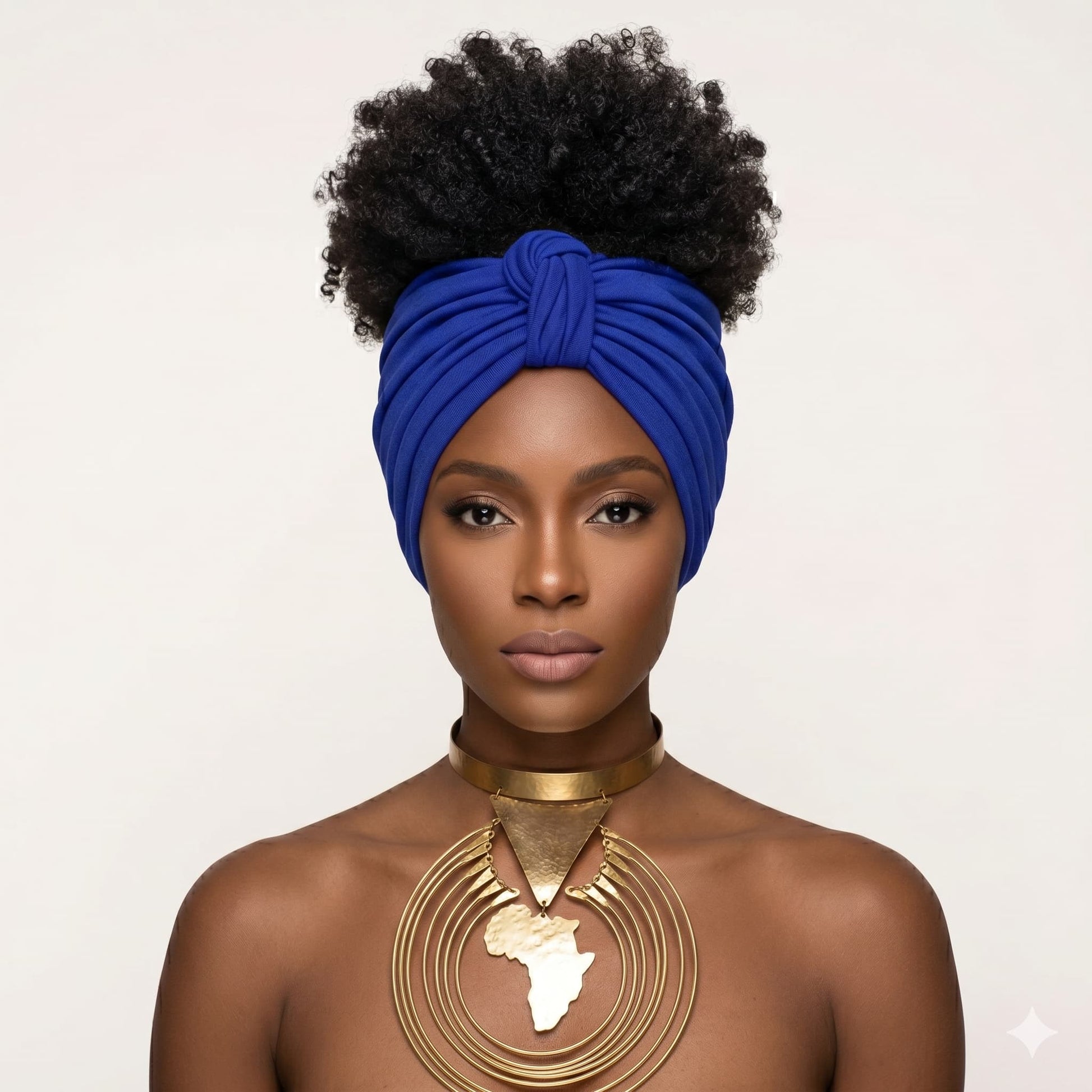 Woman wearing a blue turban and gold necklace with an African map design on a light background