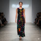 Model walking on a runway wearing a colorful tie-dye dress with 'Runway' in the background.