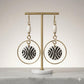 Kenyan brass,  and hand-carved bone drop earrings with black and white zebra-like patterns.