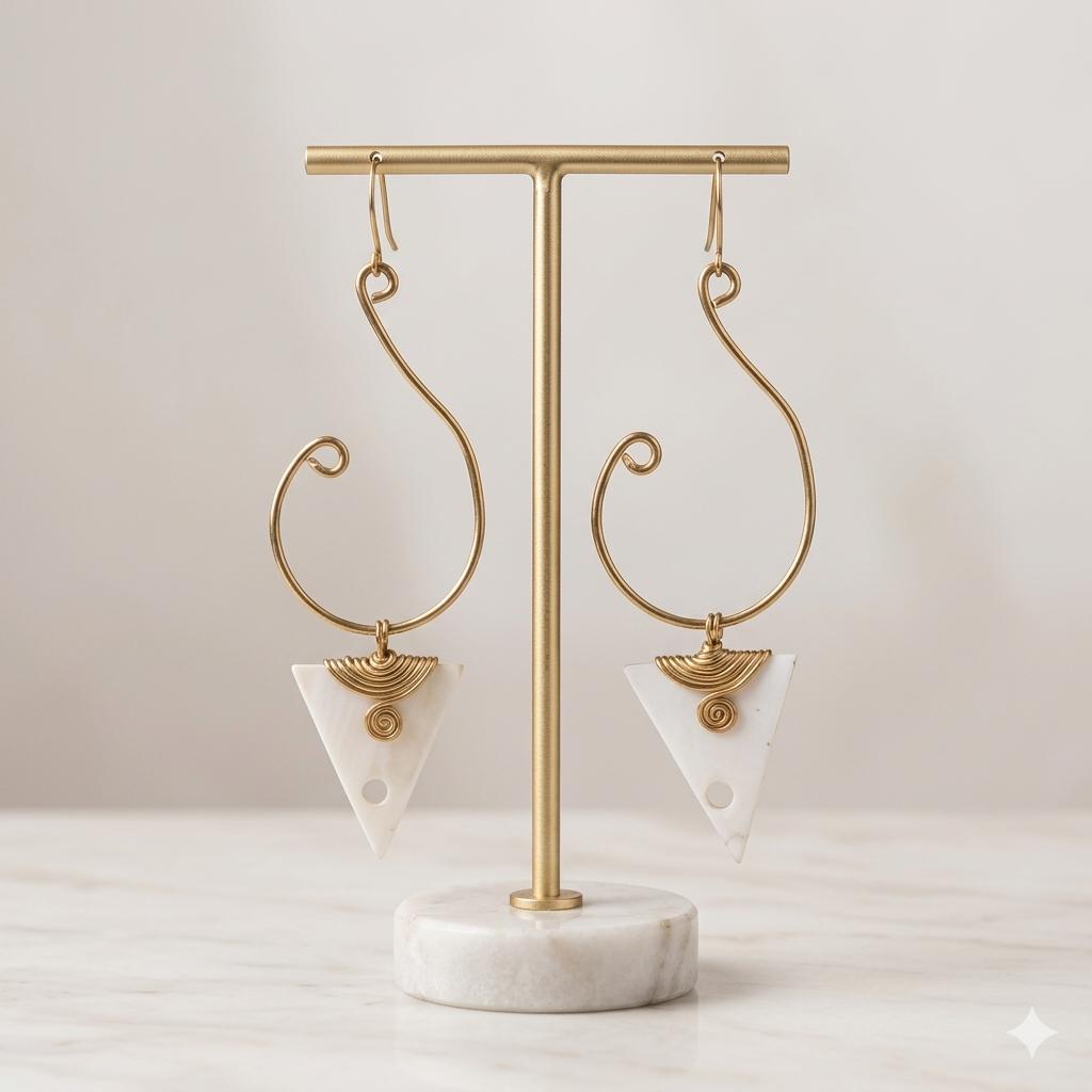 Kenyan brass, and bone drop earrings with triangular bone pendants on a gold stand.