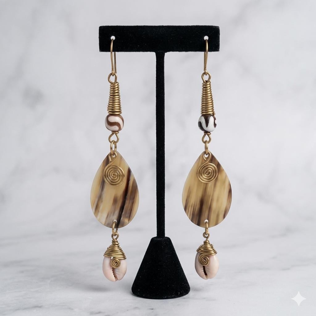 Kenyan brass, and hand-carved bone drop earrings with spiral details.