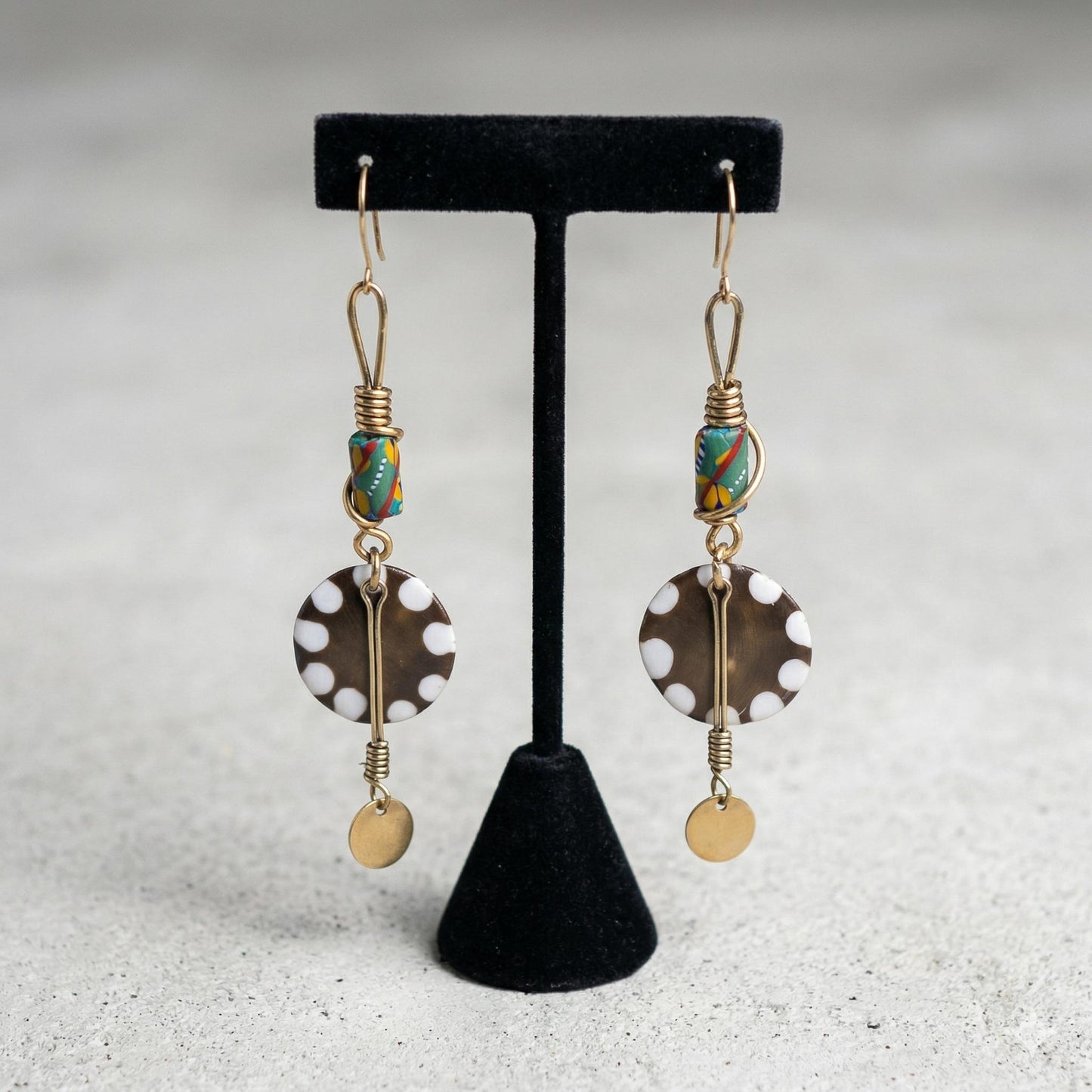 Kenyan brass, cowrie shell, and bone drop earrings with colorful beads and gold accents 
