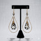 Kenyan brass teardrop earrings with black and white swirl bone drops and small bone beads.