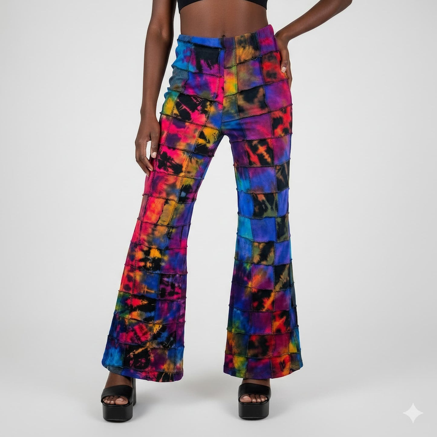 Colorful patchwork flared pants worn by a model on a white background