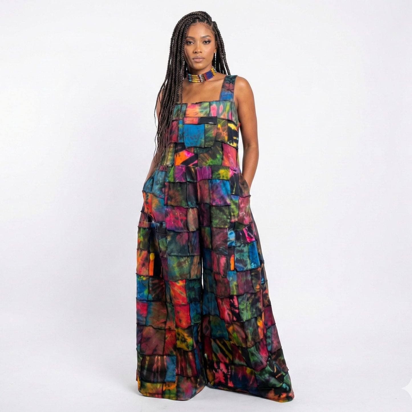 Woman wearing a colorful patchwork jumpsuit on a white background