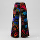 Colorful patchwork tie-dye pants on a gray background