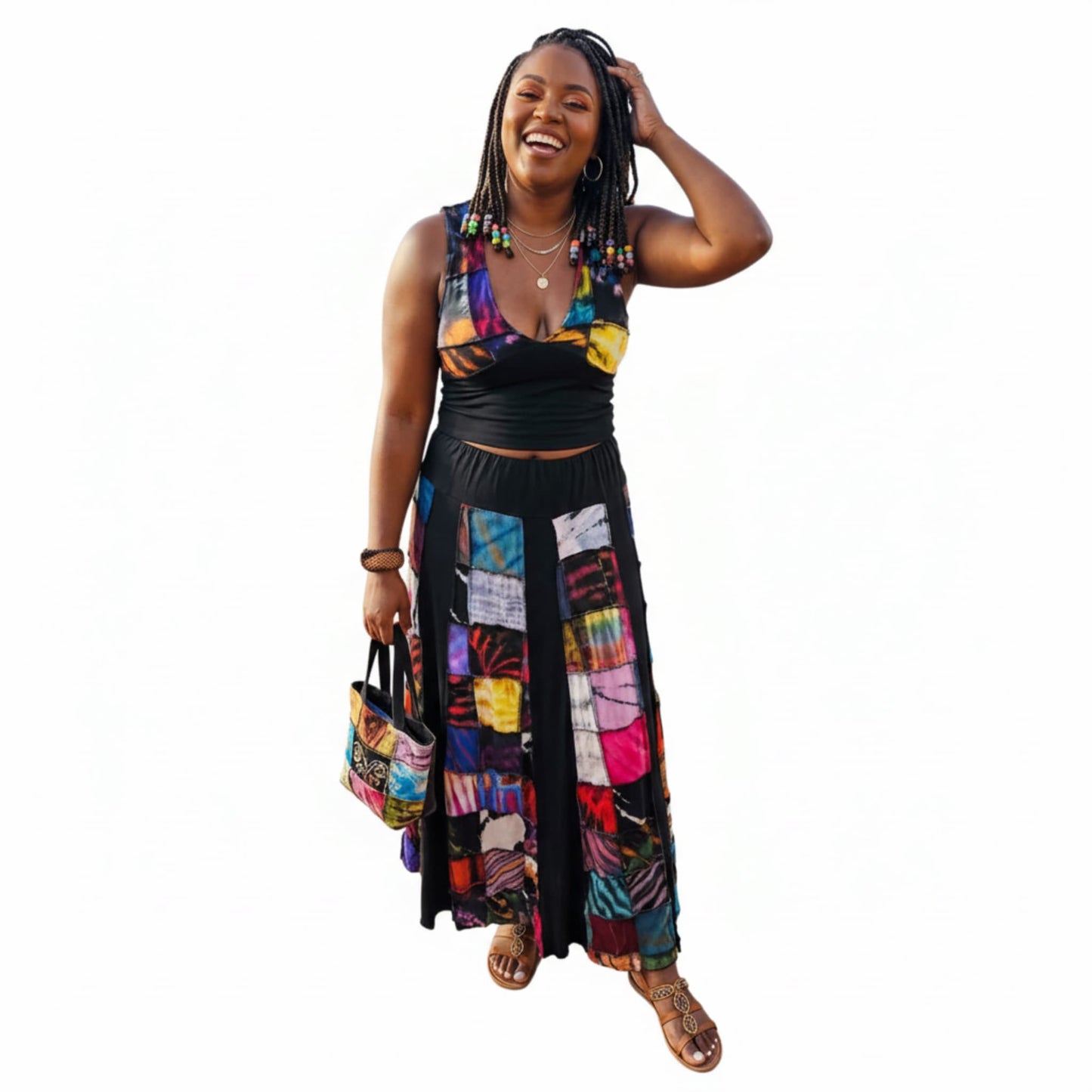 Woman wearing a colorful two piece patch outfit with a white background