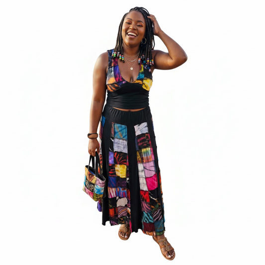 Woman wearing a colorful two piece patch outfit with a white background