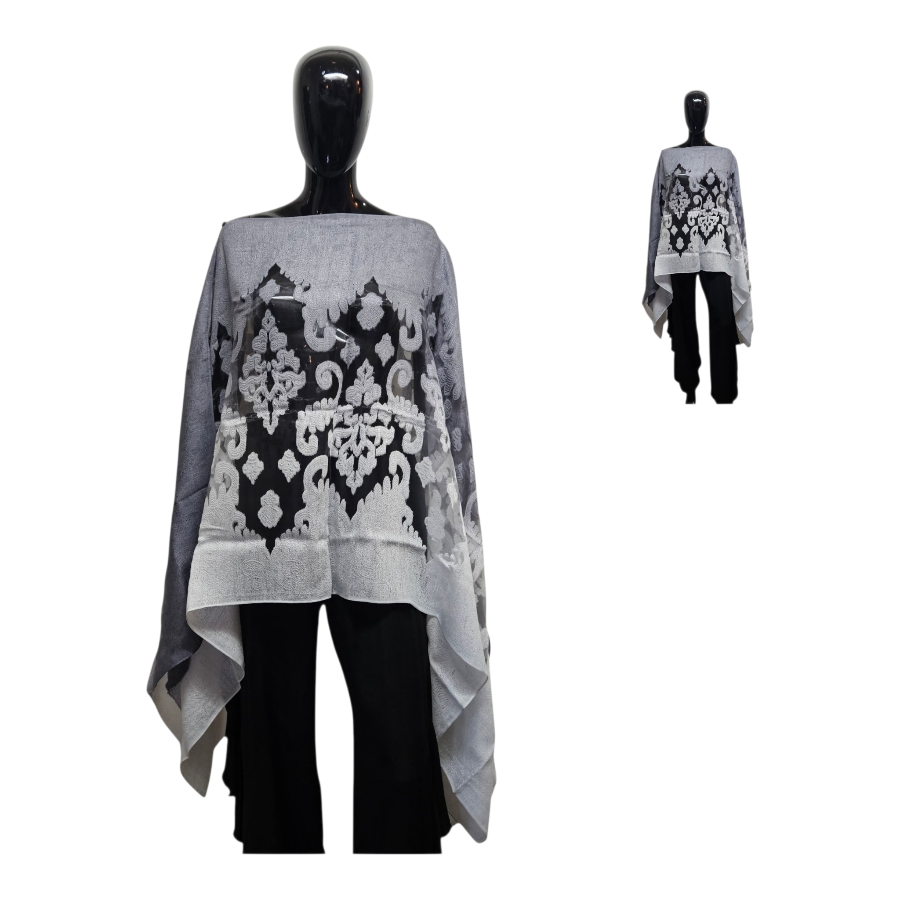 Gray poncho with black floral pattern on a mannequin against a white background