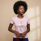 Woman wearing a pink t-shirt with a decorative clef music note design on a beige background
