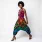 Woman wearing a tie-dye harem jumpsuit on a white background SanJules