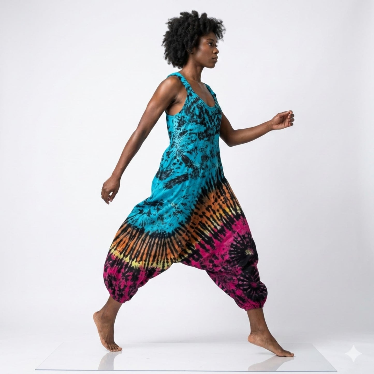 Person wearing a tie-dye harem jumpsuit on a white background SanJules