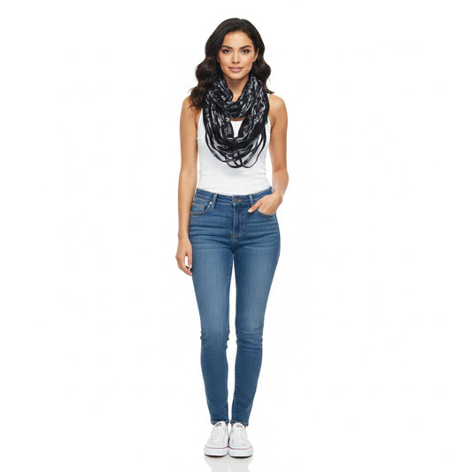 Woman wearing a white top, blue jeans, and a black and white scarf on a white background