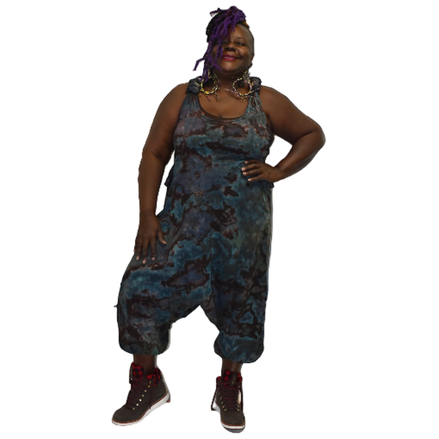 Person wearing a blue and brown patterned jumpsuit on a white background  SanJules