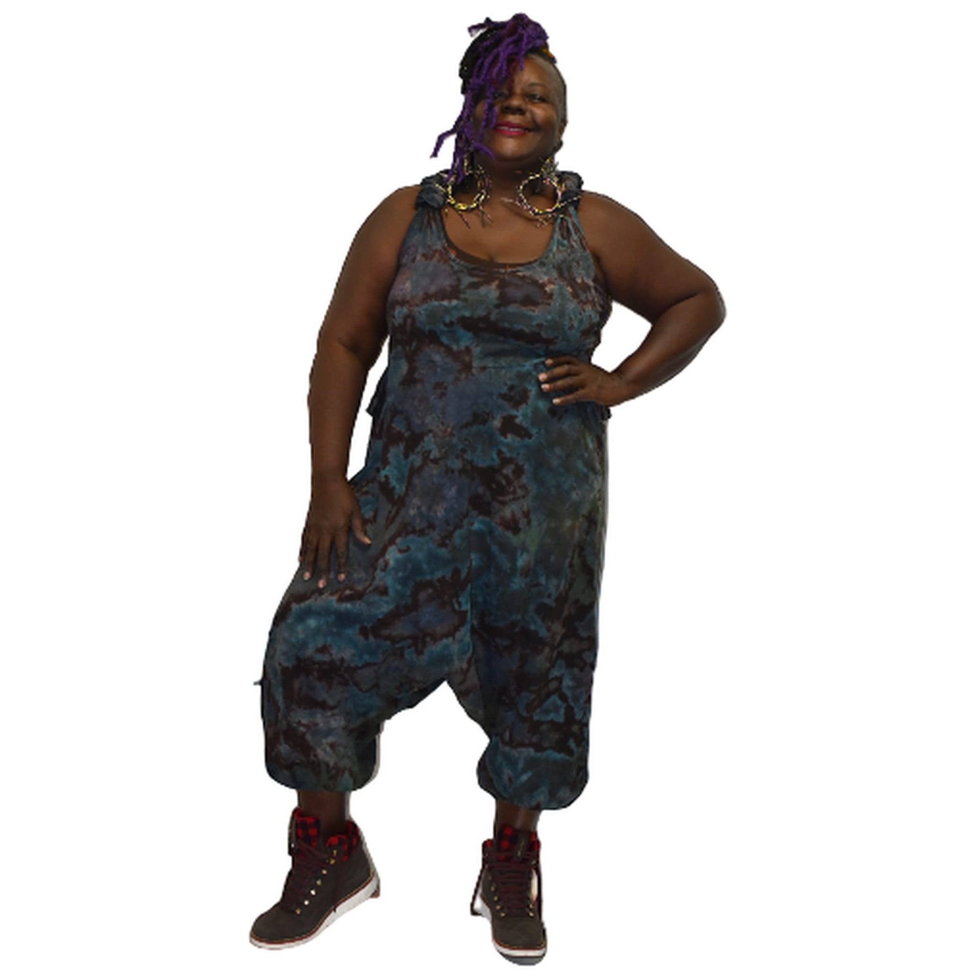 Person wearing a blue and brown patterned jumpsuit on a white background  SanJules