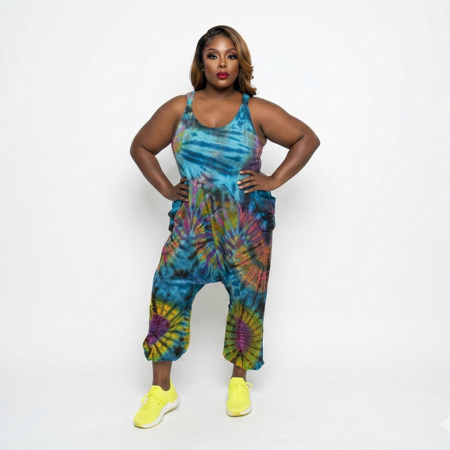 Woman wearing a tie-dye jumper with colorful patterns on a white background SanJules