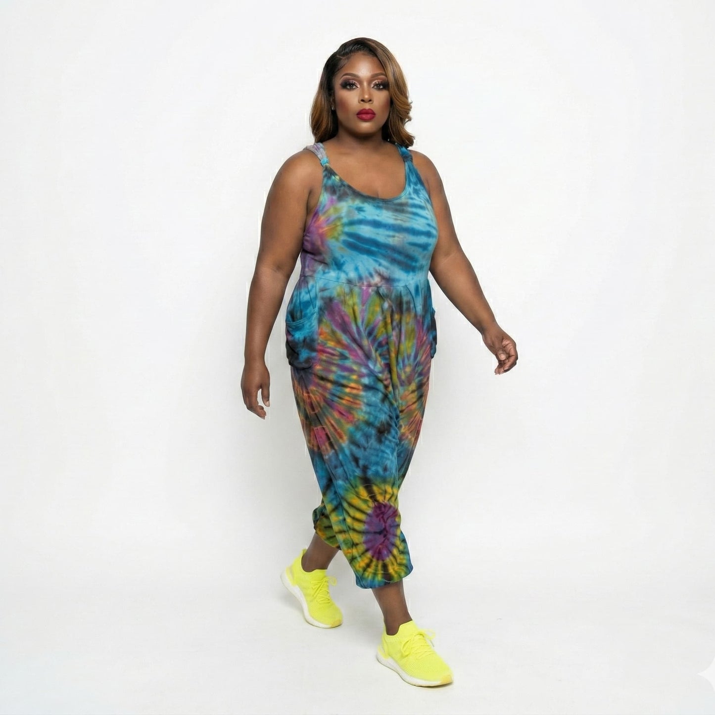 Woman wearing a tie-dye jumper with colorful patterns on a white background SanJules