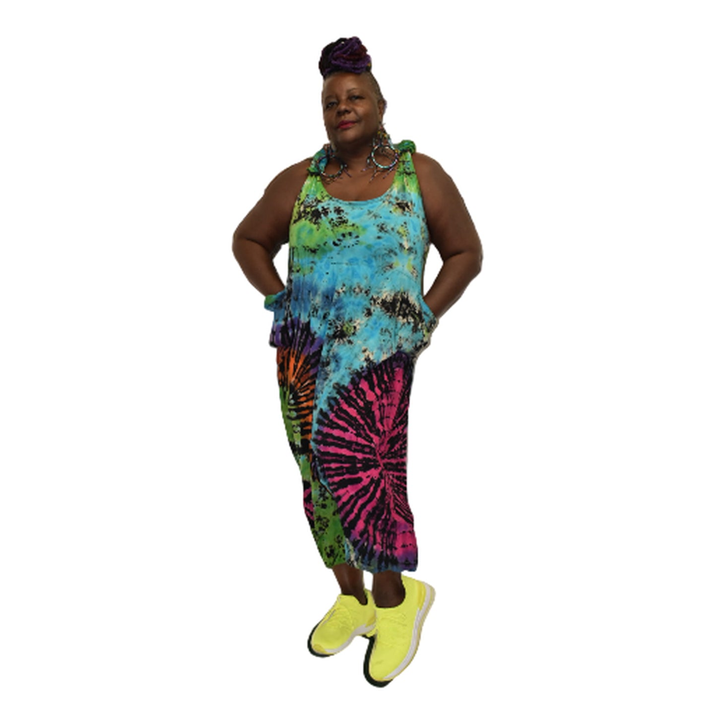 Person wearing a colorful tie-dye dress with neon shoes on a white background  SanJules