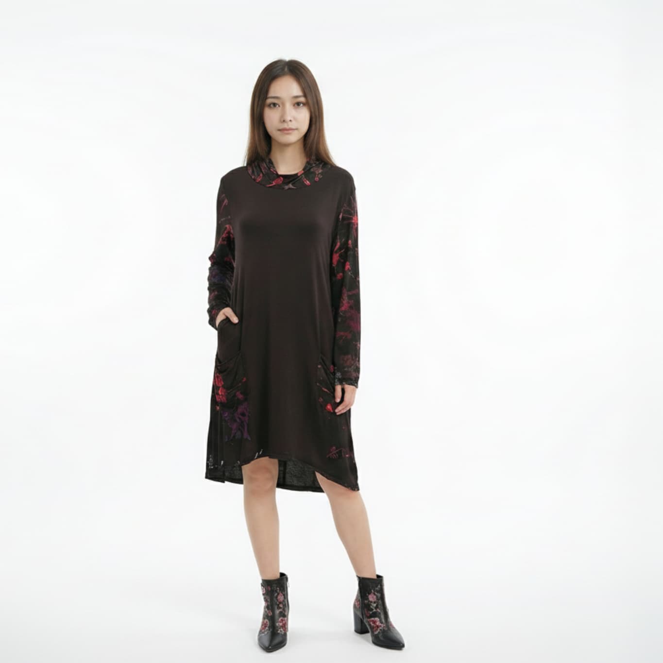 Woman wearing a black dress with floral patterns on a white background-Sanjules