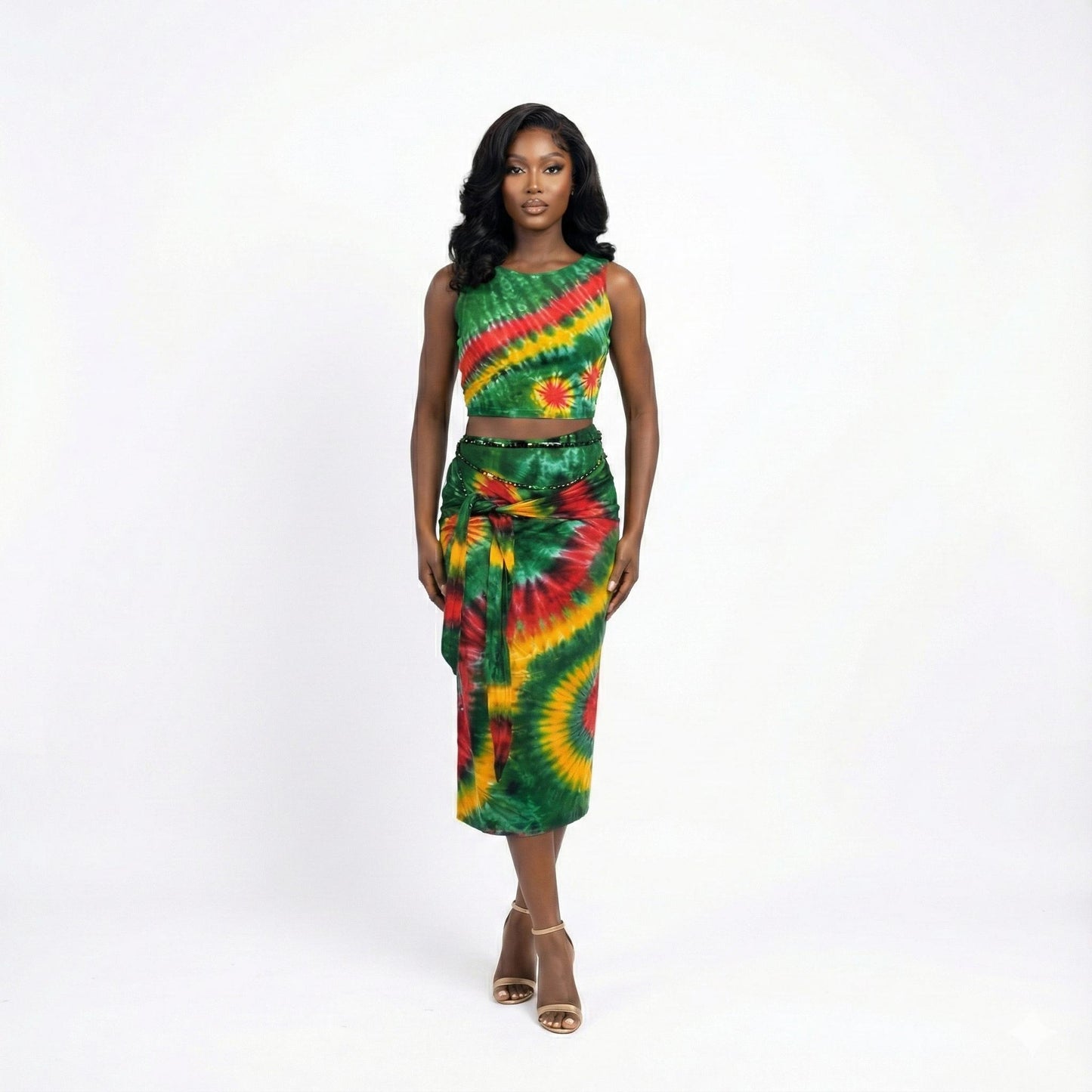 Woman wearing a green, red, and yellow tie-dye outfit on a white background SanJules