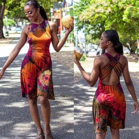 Woman wearing a colorful dress with floral patterns, standing outdoors on a sunny day.-Sanjules