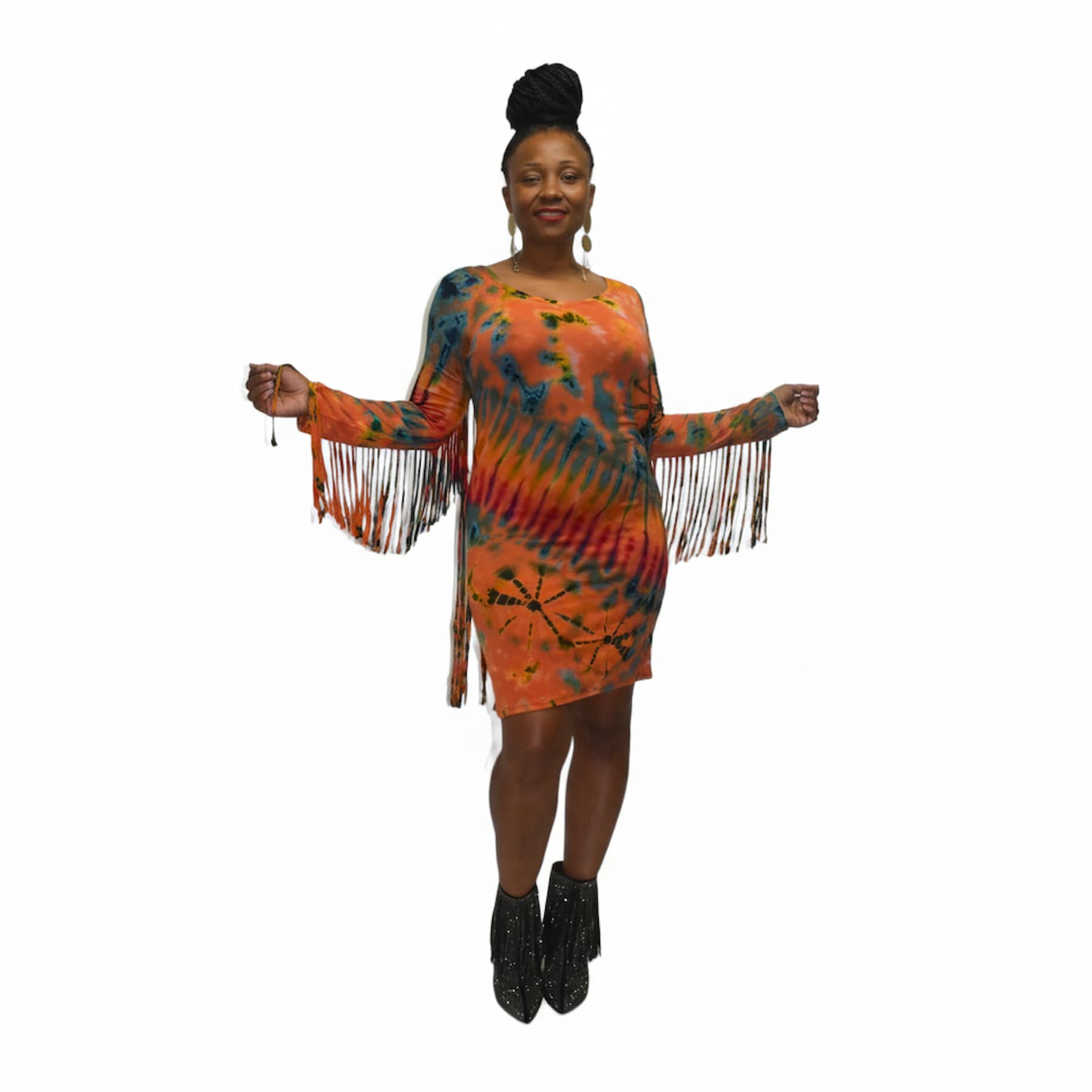 Woman wearing a tie-dye dress with fringe details on a white background. SanJules