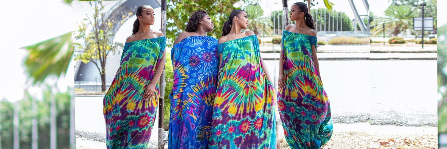 Four women wearing colorful tie-dye sarees standing outdoors.-Sanjules