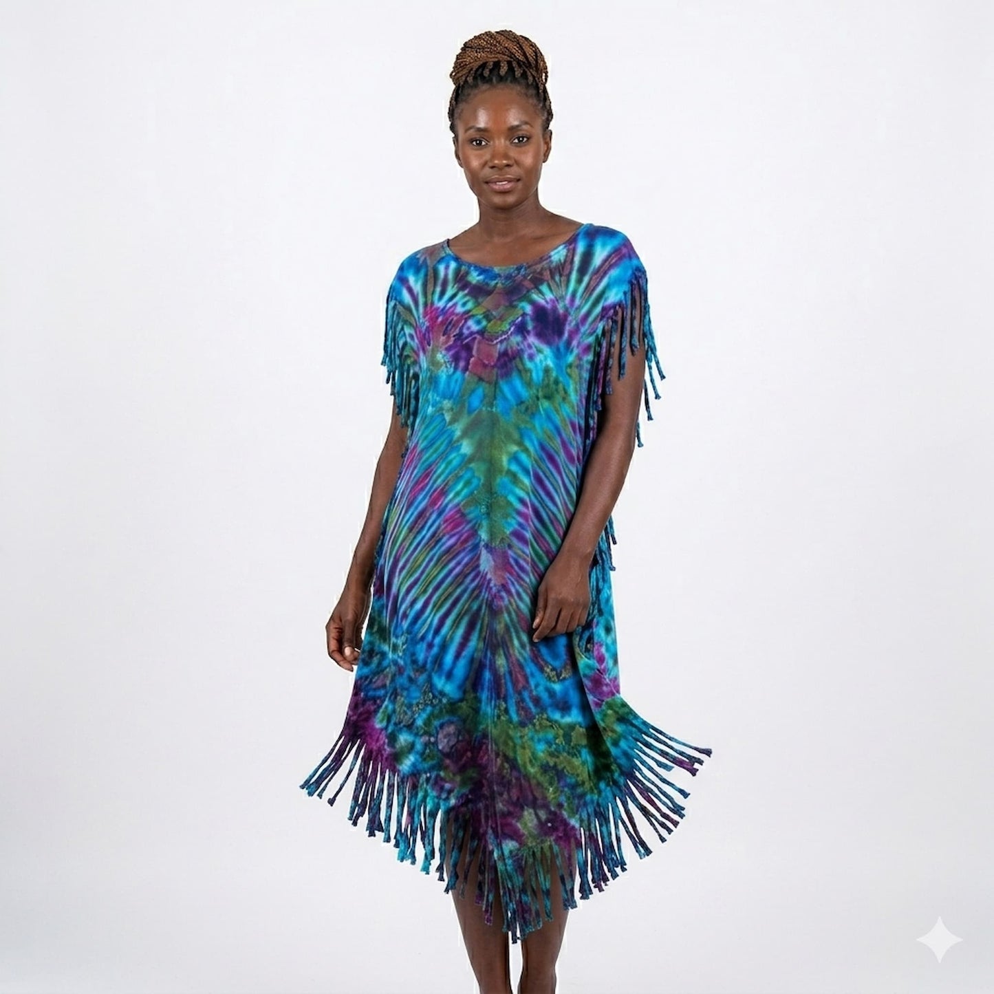 Woman wearing a colorful tie-dye dress with fringe on a white background