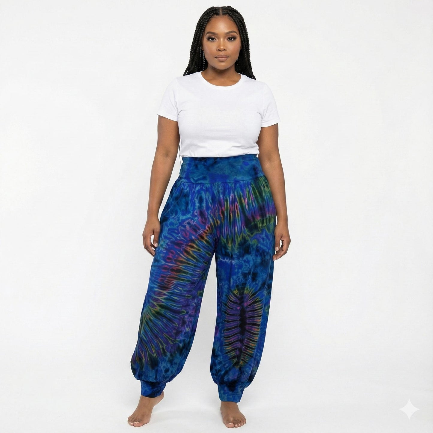 Person wearing blue tie-dye pants and a white shirt on a white background