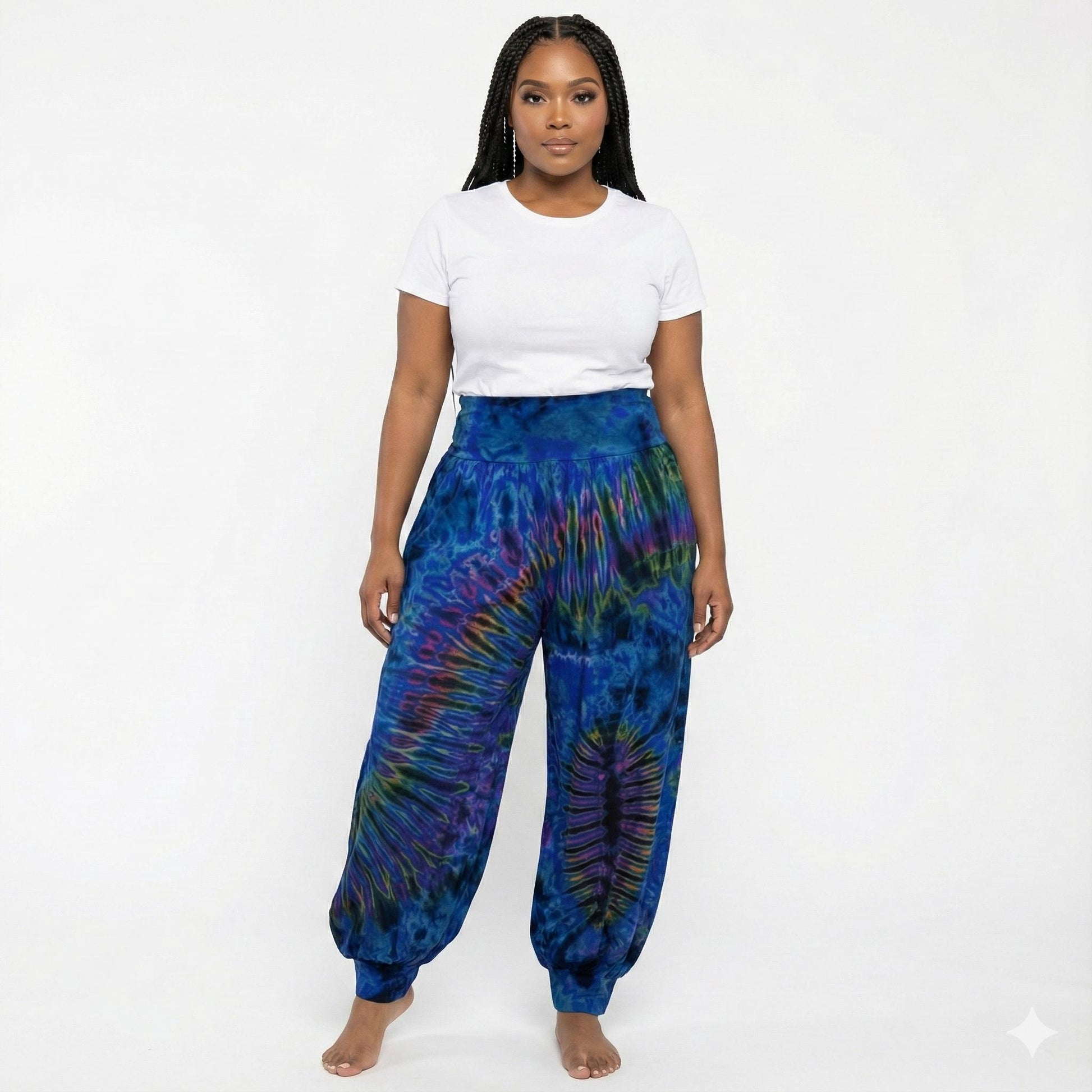 Person wearing blue tie-dye pants and a white shirt on a white background